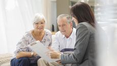 An older couple work with an adviser.