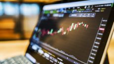 closeup of person looking at stock chart on laptop