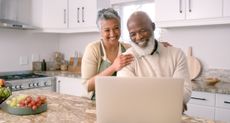 Two people looking at a computer screen.