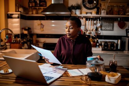 Woman doing home finances in the evening.