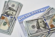 Social security card and US dollars cash money on white. 