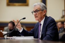 Federal Reserve Chair Jerome Powell speaking into microphone in congressional testimony